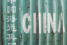 A close up of a metal shipping container with the word "China" writing on it